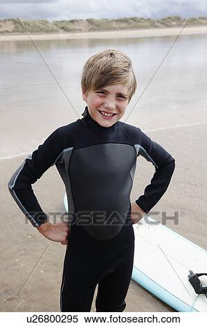 Stock Photography - Portrait of young surfer on beach. Fotosearch