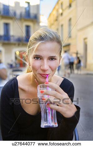 Portrait young woman with drink at cafe View Large Photo Image Stock Photo - Portrait young woman with drink at cafe. Fotosearch