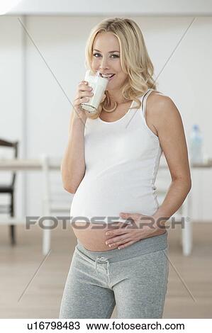 Stock Image - Pregnant woman drinking milk. Fotosearch
