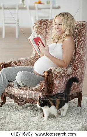Stock Photo - Pregnant woman reading. Fotosearch