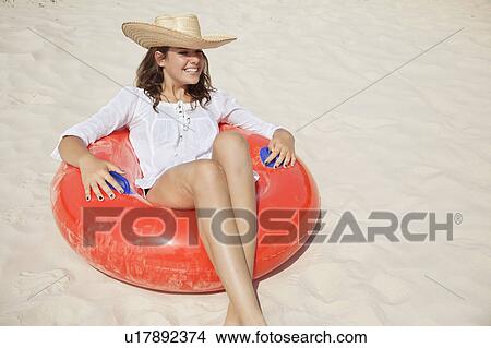 Pretty woman sitting in buoyancy ring View Large Photo Image Picture - Pretty woman sitting in buoyancy ring. Fotosearch