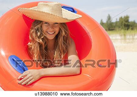 Pretty woman smiling with buoyancy ring View Large Photo Image Stock Image - Pretty woman smiling with buoyancy ring. Fotosearch