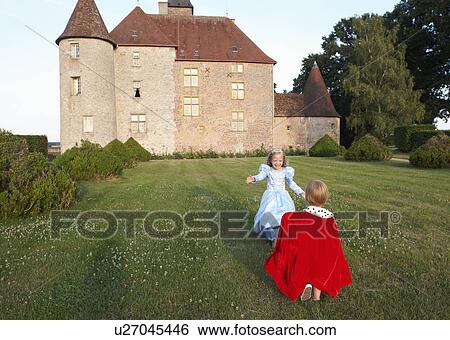 Stock Photograph - Prince and princess in castle's garden. Fotosearch