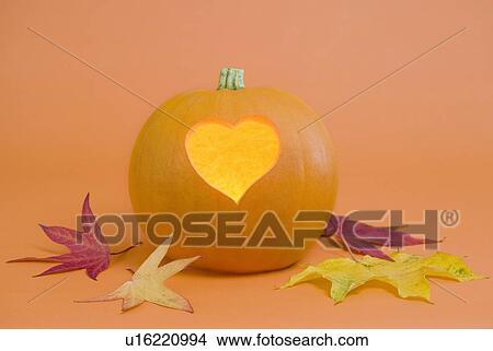 Picture - Pumpkin with heart-shape lit from inside. Fotosearch