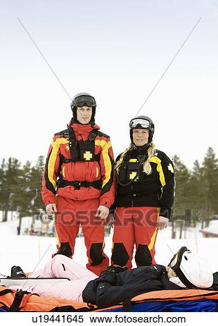 Stock Photography - Rescue Team with Skier. Fotosearch