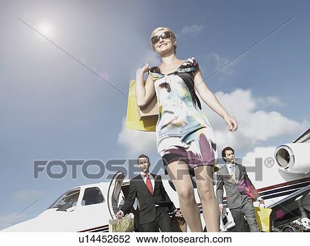 Stock Image - Rich woman traveling in private jet. Fotosearch