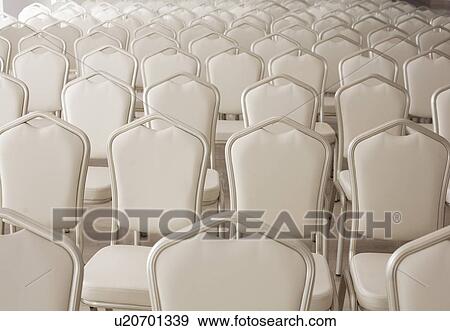 Rows of empty white chairs View Large Photo Image Stock Photo - Rows of empty white chairs. Fotosearch