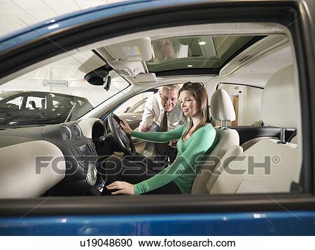 Salesman shows customer a car View Large Photo Image Stock Image - Salesman shows customer a car. Fotosearch