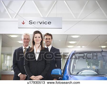 Salespeople with car in car dealership View Large Photo Image Stock Image - Salespeople with car in car dealership. Fotosearch