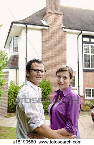 Satisfied couple outside new home View Large Photo Image Stock Image - Satisfied couple outside new home. Fotosearch