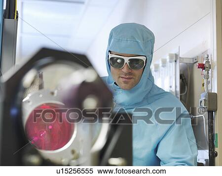 Stock Photography - Scientist in laboratory with laser. Fotosearch