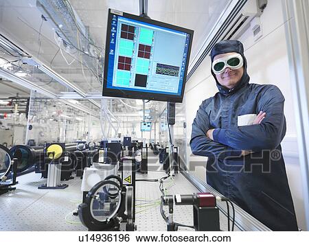 Stock Photograph - Scientist in laser laboratory. Fotosearch
