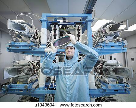 Scientist inspecting laser lens View Large Photo Image Stock Image - Scientist inspecting laser lens. Fotosearch