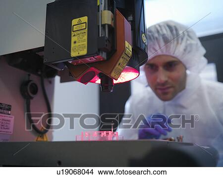 Picture - Scientist measures fusion target. Fotosearch