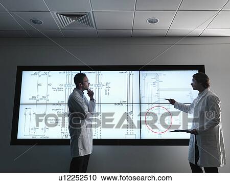 Scientist with diagrams on screen View Large Photo Image Stock Image - Scientist with diagrams on screen. Fotosearch