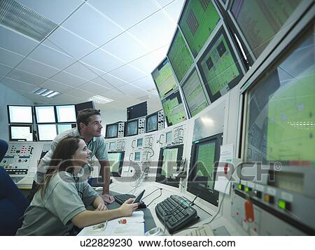 Scientists in accelerator control room View Large Photo Image Stock Image - Scientists in accelerator control room. Fotosearch