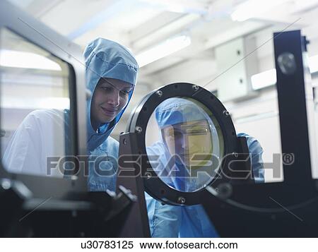 Stock Photography - Scientists inspecting laser filter. Fotosearch