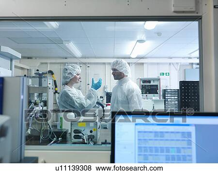 Stock Photo - Scientists looking at fusion target. Fotosearch