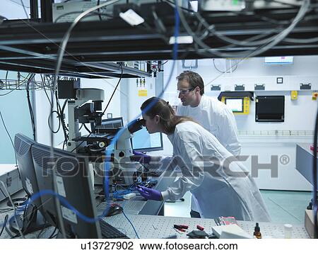 Scientists using laser microscope View Large Photo Image Stock Image - Scientists using laser microscope. Fotosearch