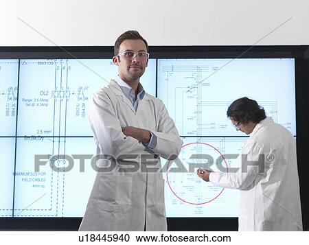 Stock Image - Scientists with diagrams on screen. Fotosearch