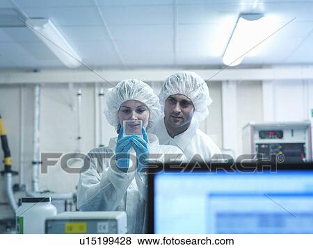 Stock Photo - Scientists with fusion target. Fotosearch