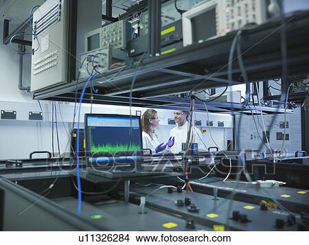 Scientists with laser experiment View Large Photo Image Picture - Scientists with laser experiment. Fotosearch