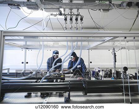 Scientists working with laser View Large Photo Image Stock Image - Scientists working with laser. Fotosearch