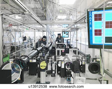 Scientists working with laser View Large Photo Image Stock Photo - Scientists working with laser. Fotosearch