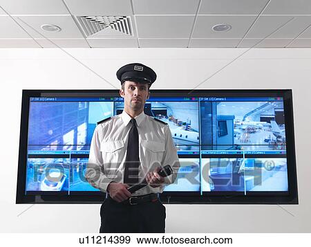 Stock Photo - Security guard in control room. Fotosearch