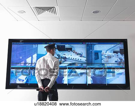 Stock Photo - Security guard in control room. Fotosearch