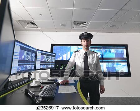 Stock Photo - Security guard in control room. Fotosearch