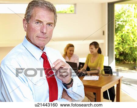 Stock Image - Senior business man and colleagues. Fotosearch