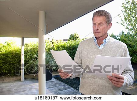 Senior business man reads data View Large Photo Image Stock Photo - Senior business man reads data. Fotosearch