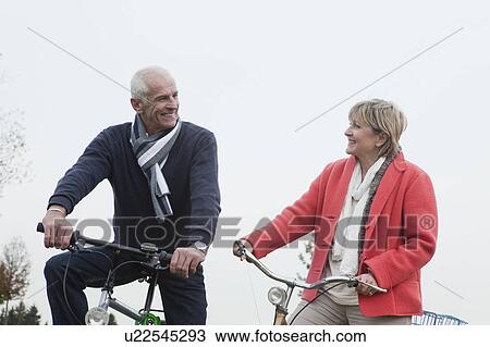 Senior couple riding bikes View Large Photo Image Stock Image - Senior couple riding bikes. Fotosearch