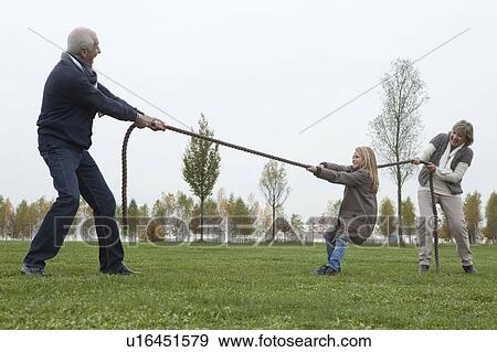 Stock Photo - Seniors playing tug-of-war. Fotosearch