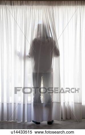 Silhouette of figure through curtains View Large Photo Image Stock Photography - Silhouette of figure through curtains. Fotosearch
