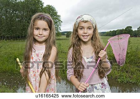 Sisters fishing by the river View Large Photo Image Stock Photography - Sisters fishing by the river. Fotosearch