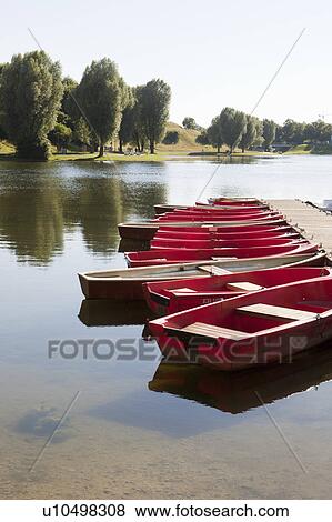 Stock Photo - Small boats tied on a jetty. Fotosearch