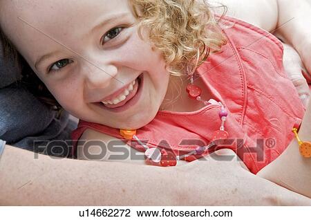 Smiling girl in her mums arms View Large Photo Image Stock Image - Smiling girl in her mums arms. Fotosearch
