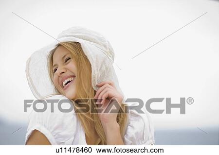 Stock Image - Smiling woman with hat. Fotosearch