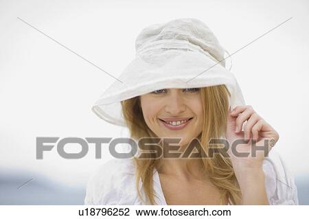 Smiling woman with hat View Large Photo Image Stock Image - Smiling woman with hat. Fotosearch