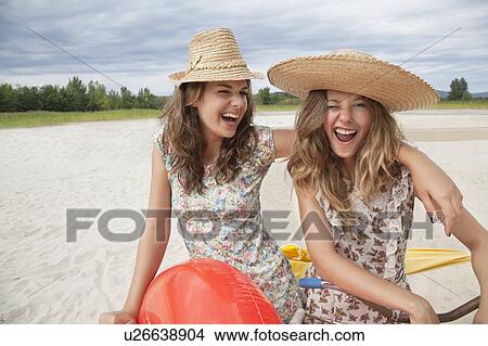 Smiling women having fun on the beach View Large Photo Image Picture - Smiling women having fun on the beach. Fotosearch