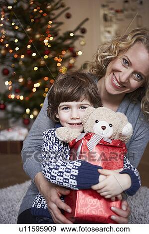 Son sitting on mothers lap View Large Photo Image Stock Photo - Son sitting on mothers lap. Fotosearch