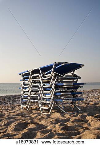 Stack of sunloungers on the beach View Large Photo Image Stock Image - Stack of sunloungers on the beach. Fotosearch