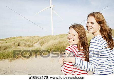 Teenagers in front of wind turbine View Large Photo Image Stock Photograph - Teenagers in front of wind turbine. Fotosearch