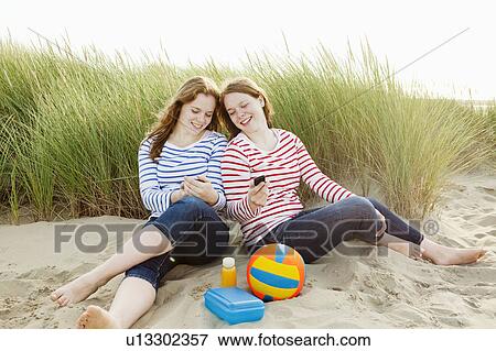 Teenagers texting and comparing messages View Large Photo Image Stock Photo - Teenagers texting and comparing messages. Fotosearch