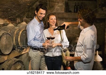 Stock Photo - Three people tasting wine. Fotosearch