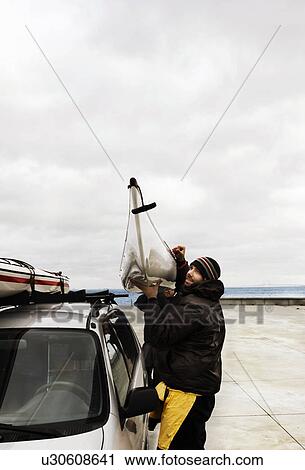 Stock Image - To men Carry Kayak. Fotosearch