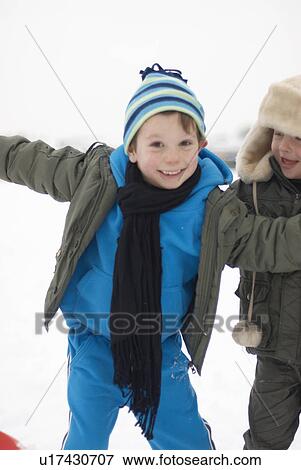 Tow boys out in the snow View Large Photo Image Stock Photo - Tow boys out in the snow. Fotosearch