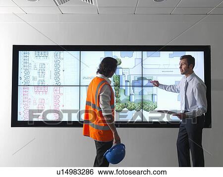 Stock Photograph - Town planners look at plans on screen. Fotosearch